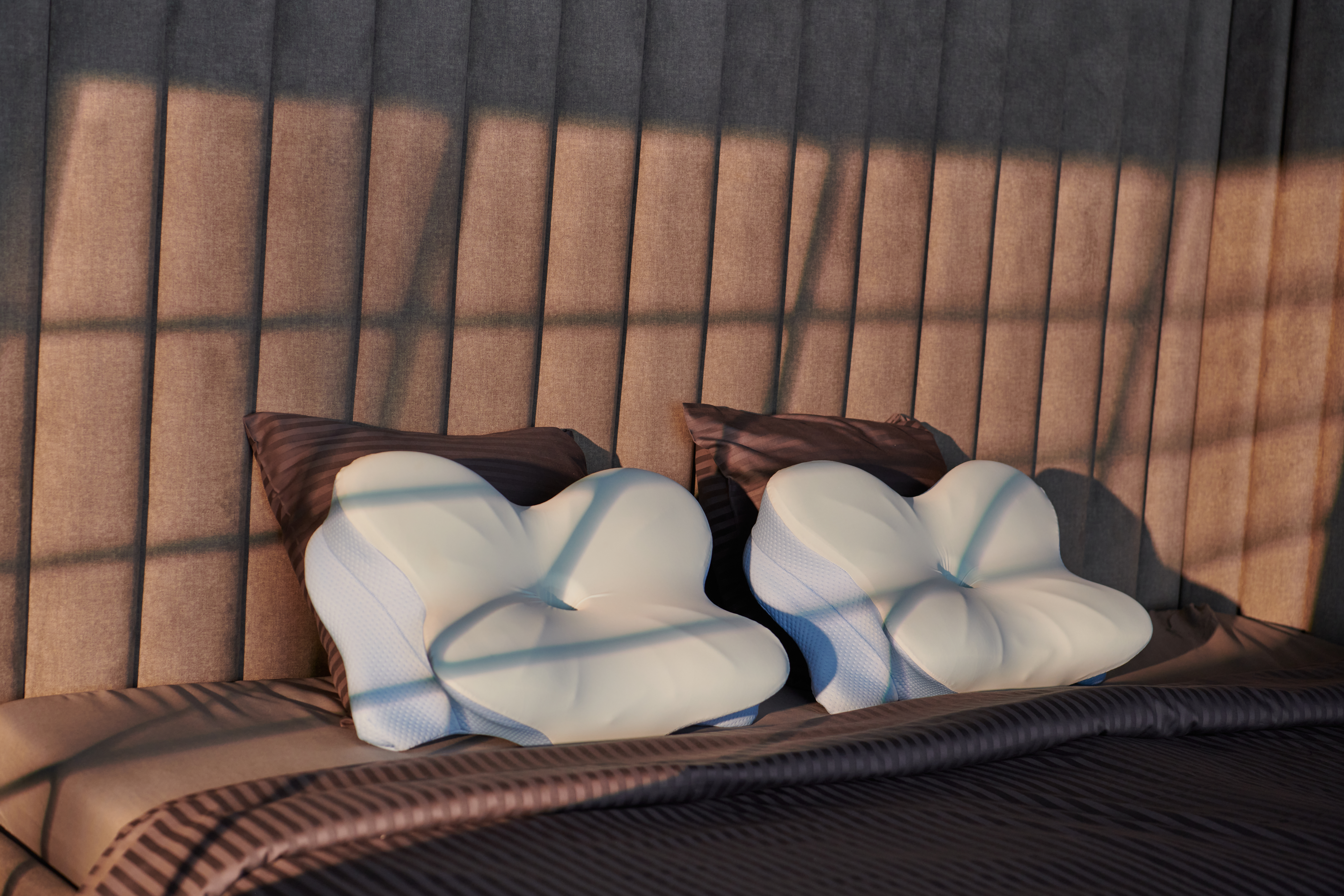 Two Derila ergonomic memory foam pillows in a bedroom setting