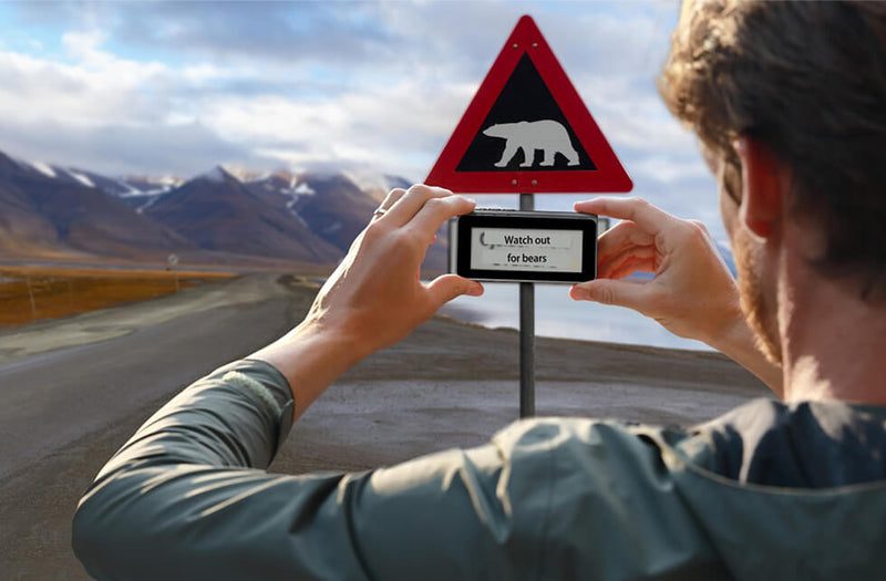 Traveler using the NEW T1 camera to translate a road sign